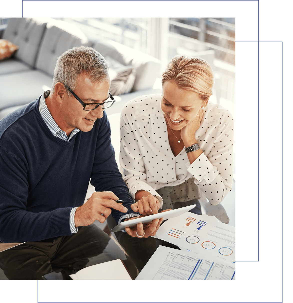 Two people discussing work on tablet.