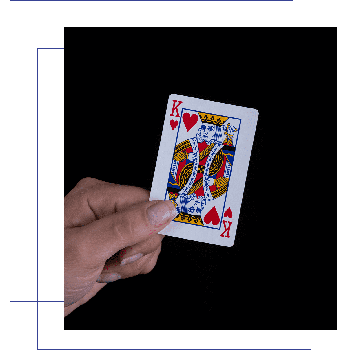 Hand holding King of Hearts card.